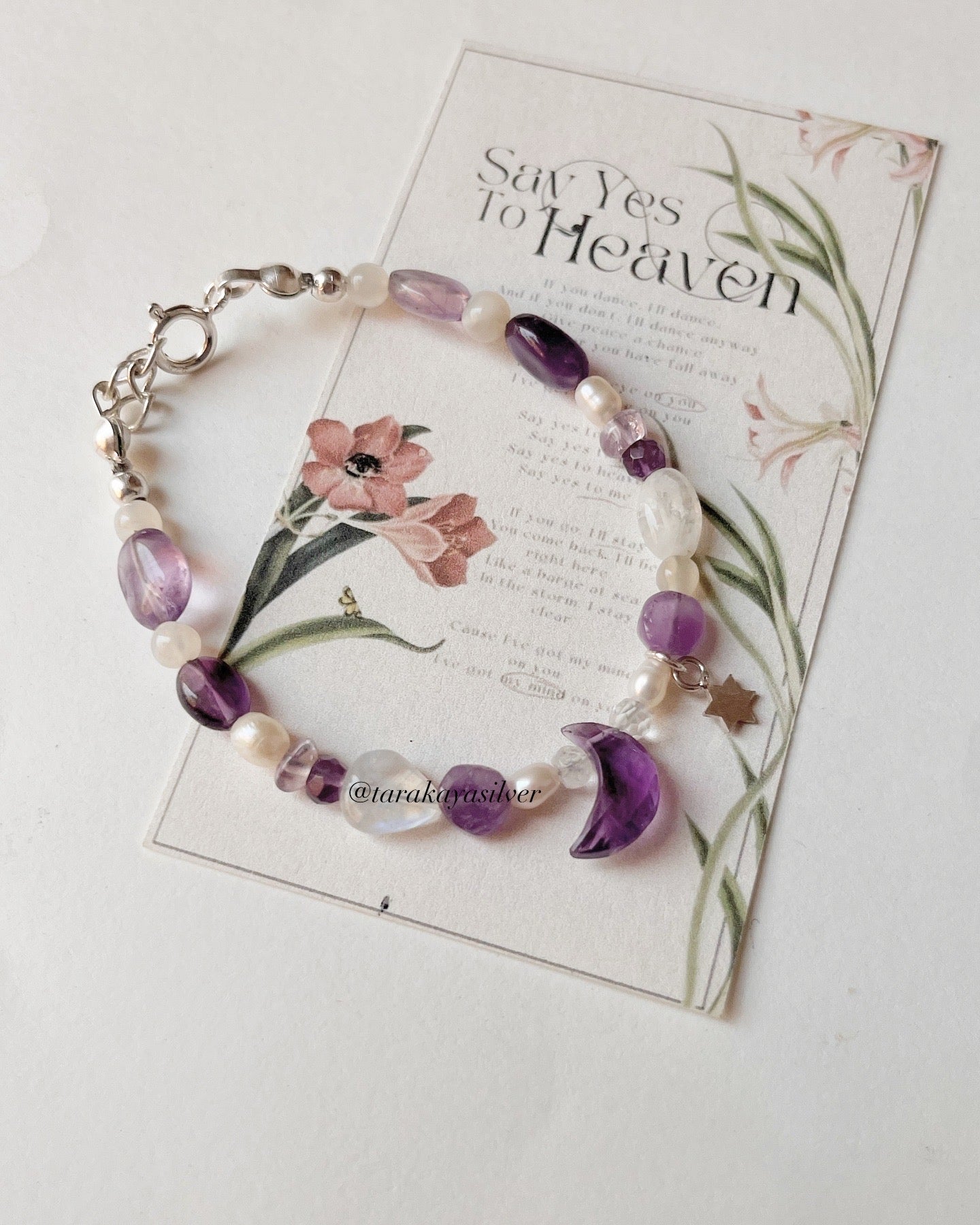 Lunar-inspired silver charm bracelet with amethyst accents