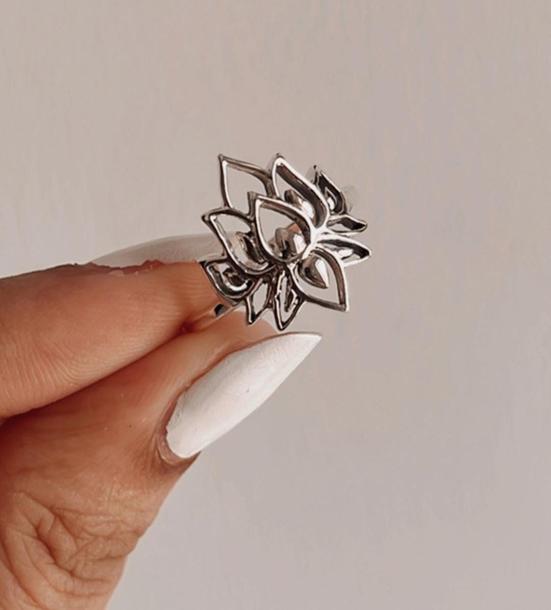 Bold big lotus silver ring with intricate floral design.