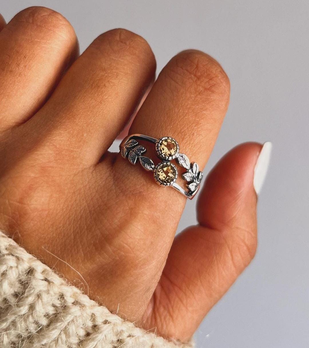 Close-up of citrine forest enchantment silver ring with leaf and vine details