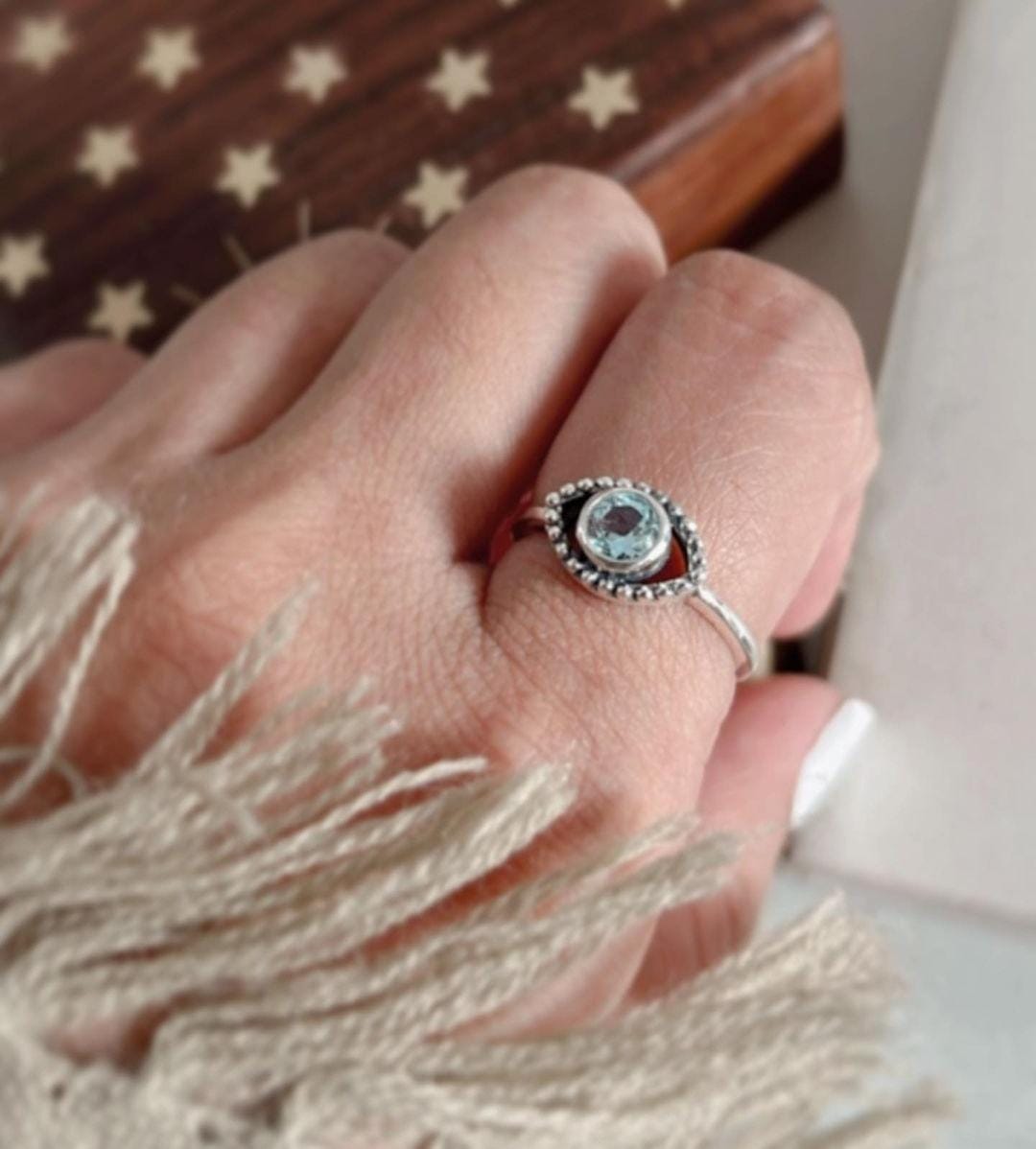 Stylish evil eye silver ring with blue topaz and boho detailing