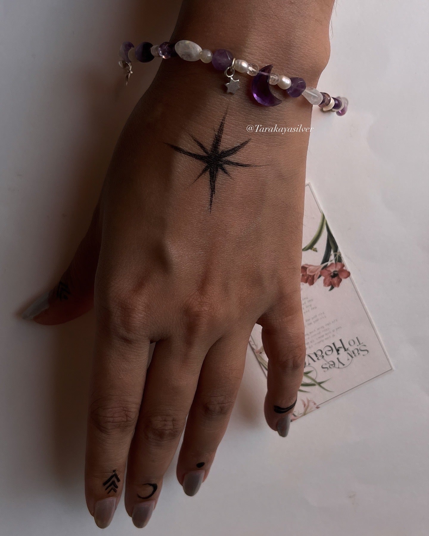 Celestial-themed silver bracelet with amethyst moon charm