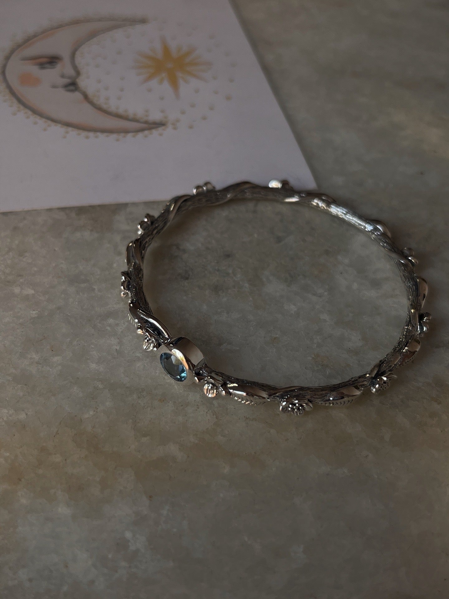 Artisan 925 sterling silver bangle with blue topaz forest design