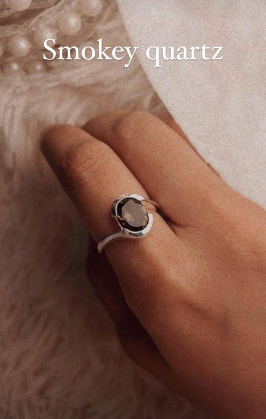 Handcrafted silver ring featuring smokey quartz cross and oval cut
