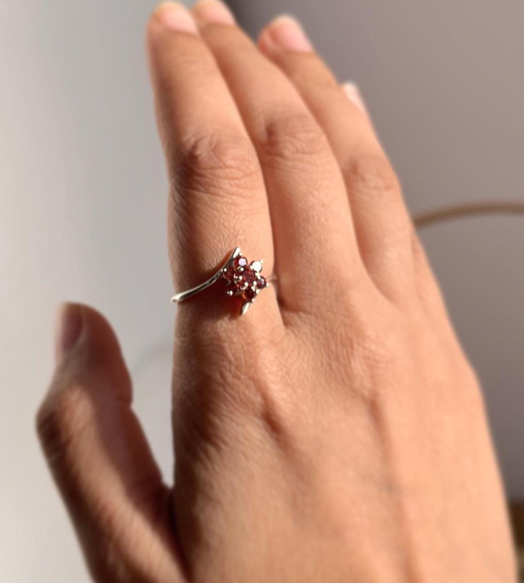 Elegant garnet flower statement ring with intricate silver details