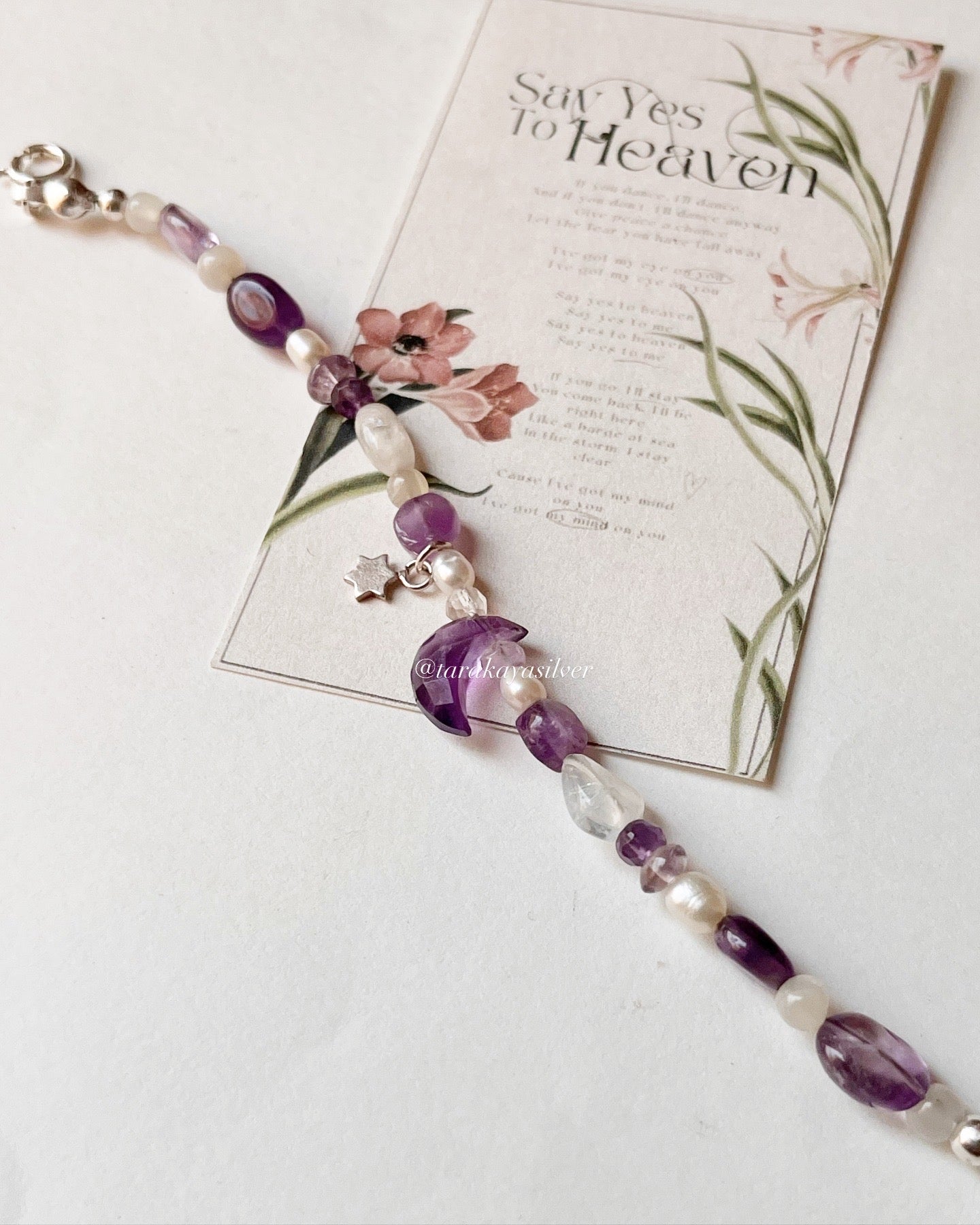 Celestial-themed silver bracelet with amethyst moon charm