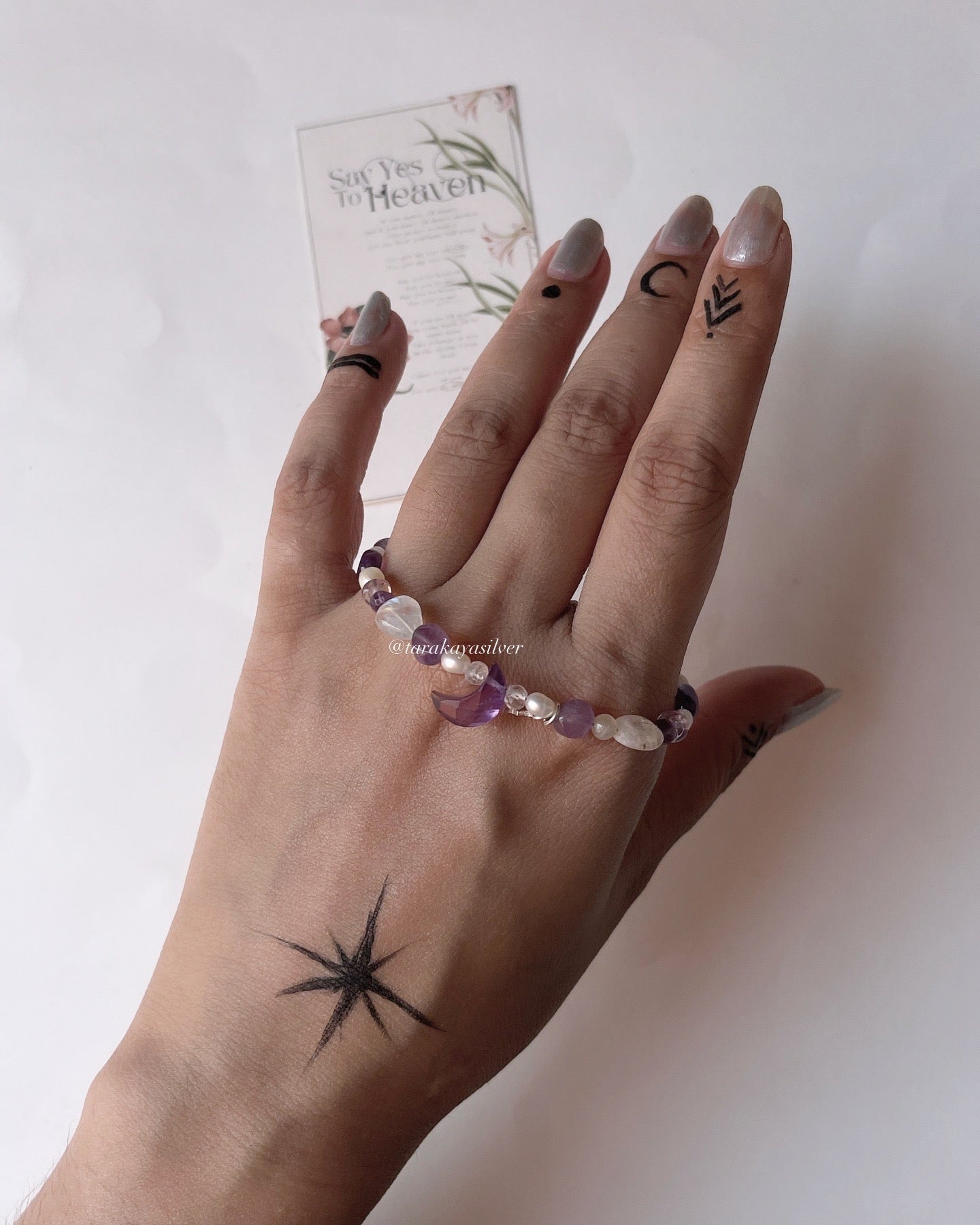 Elegant sterling silver bracelet with amethyst moon & star details