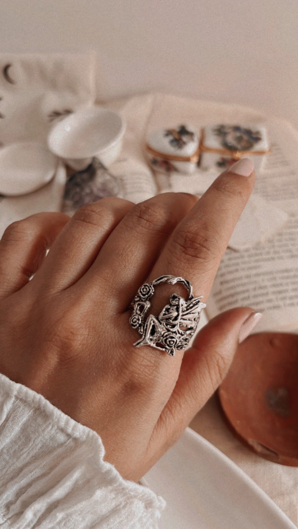 Whimsical fairy in forest silver ring featuring intricate detailing