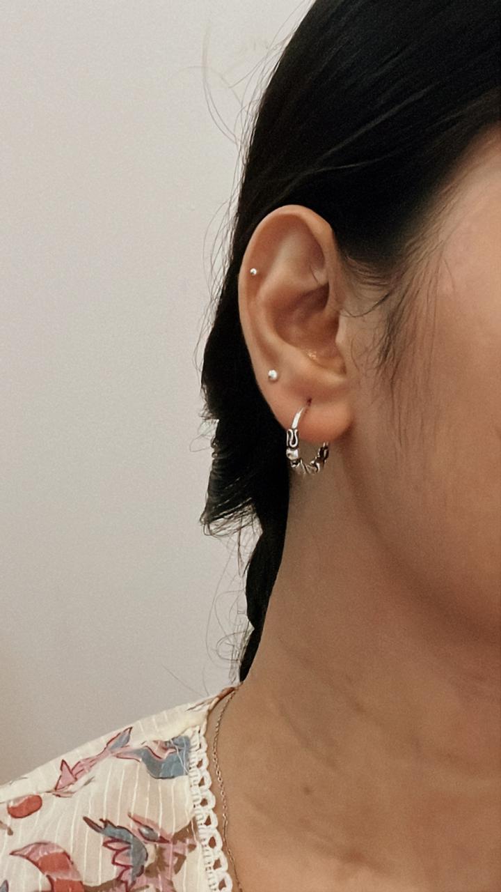 Elegant antique silver hoop earrings with a unique design 2.
