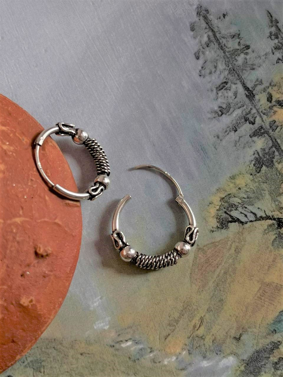 Handcrafted antique silver hoop earrings with an elegant design 2.