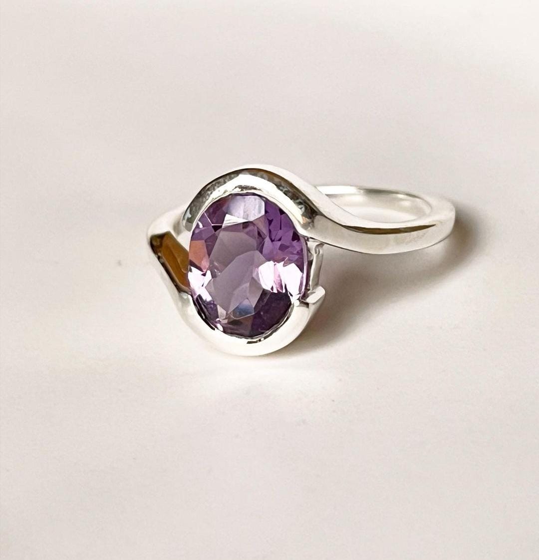 Elegant Silver Ring Featuring Oval Faceted Amethyst and Cross Motif