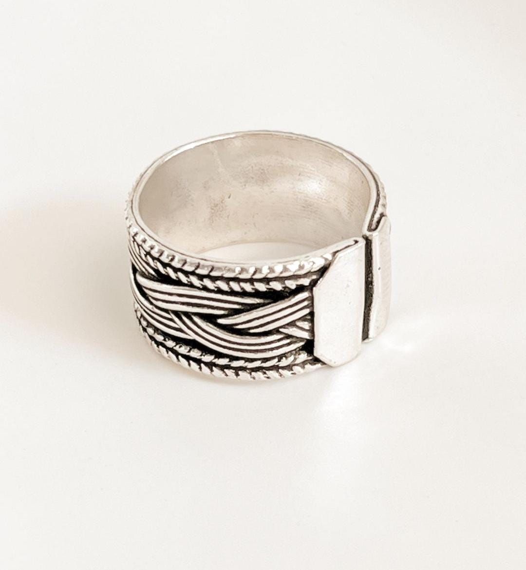 Tribal braided band ring with intricate silver design