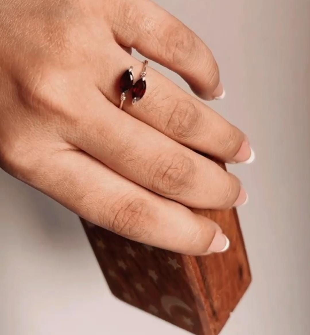 Silver ring with two marquise garnet stones set in a sleek design