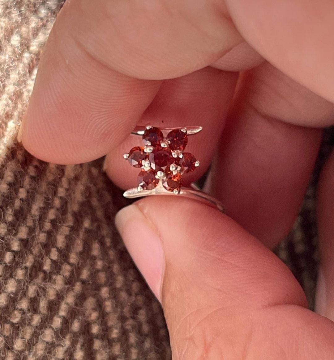 Statement silver ring with a vibrant garnet flower centerpiece