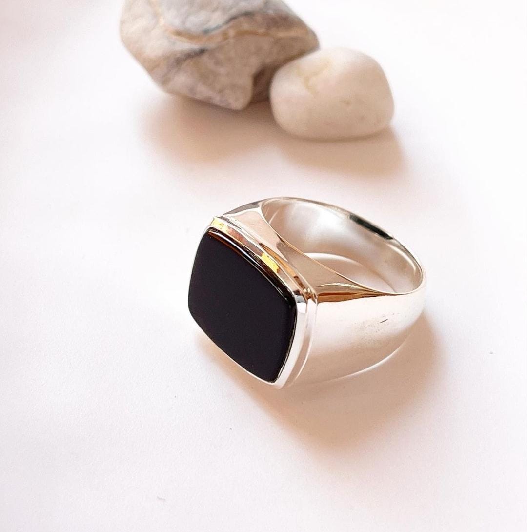 Elegant black onyx signet ring with a faceted, geometric cut.