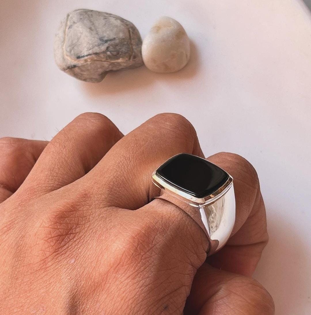 Sleek big black onyx signet ring with a faceted finish in sterling silver.