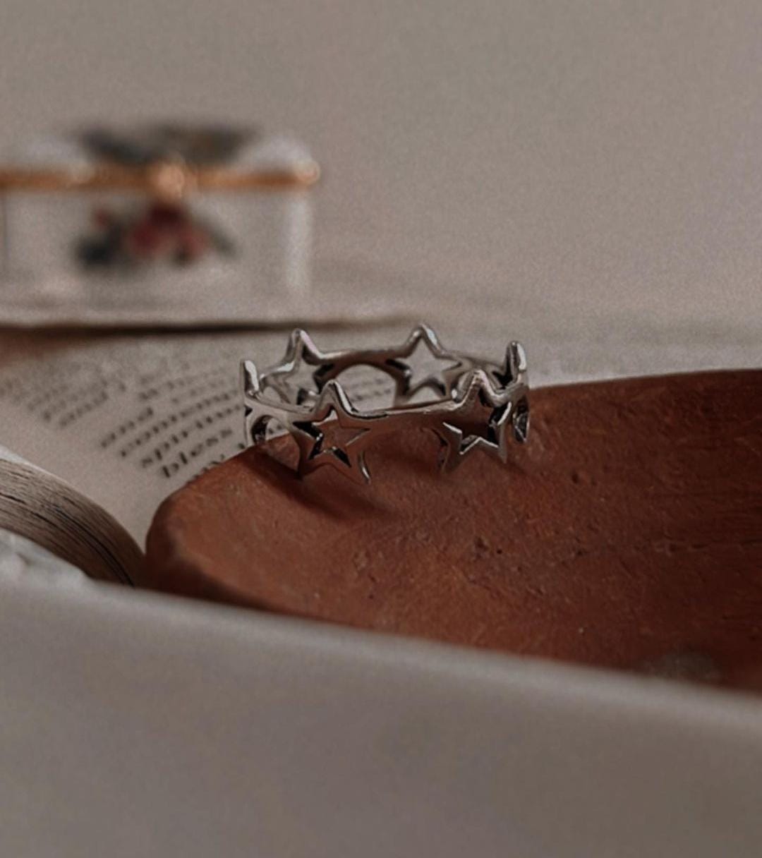 Sterling silver ring featuring a round band with star pattern