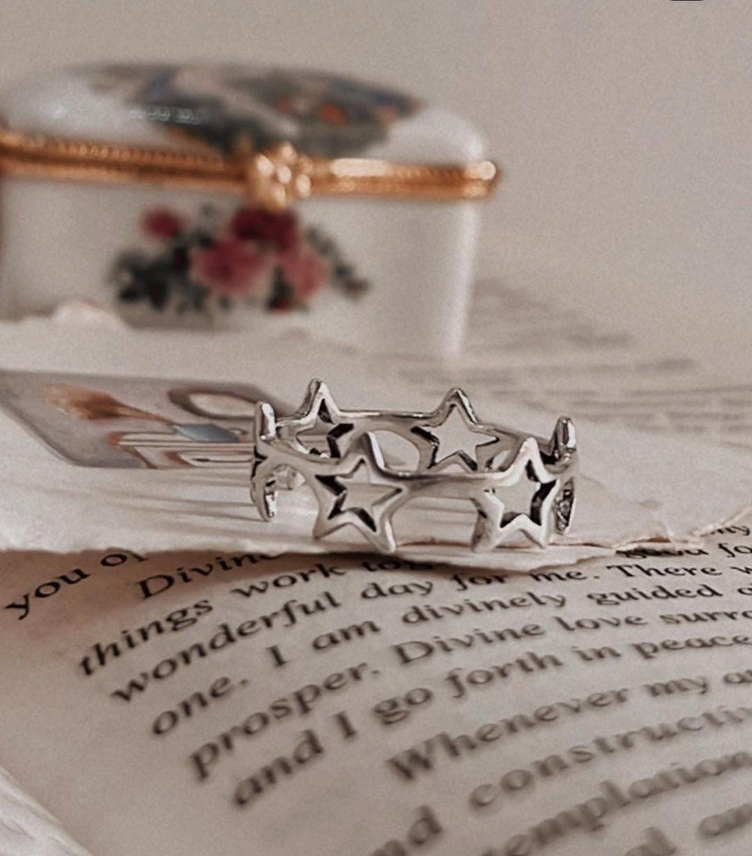 Charming silver ring with round band and star motifs