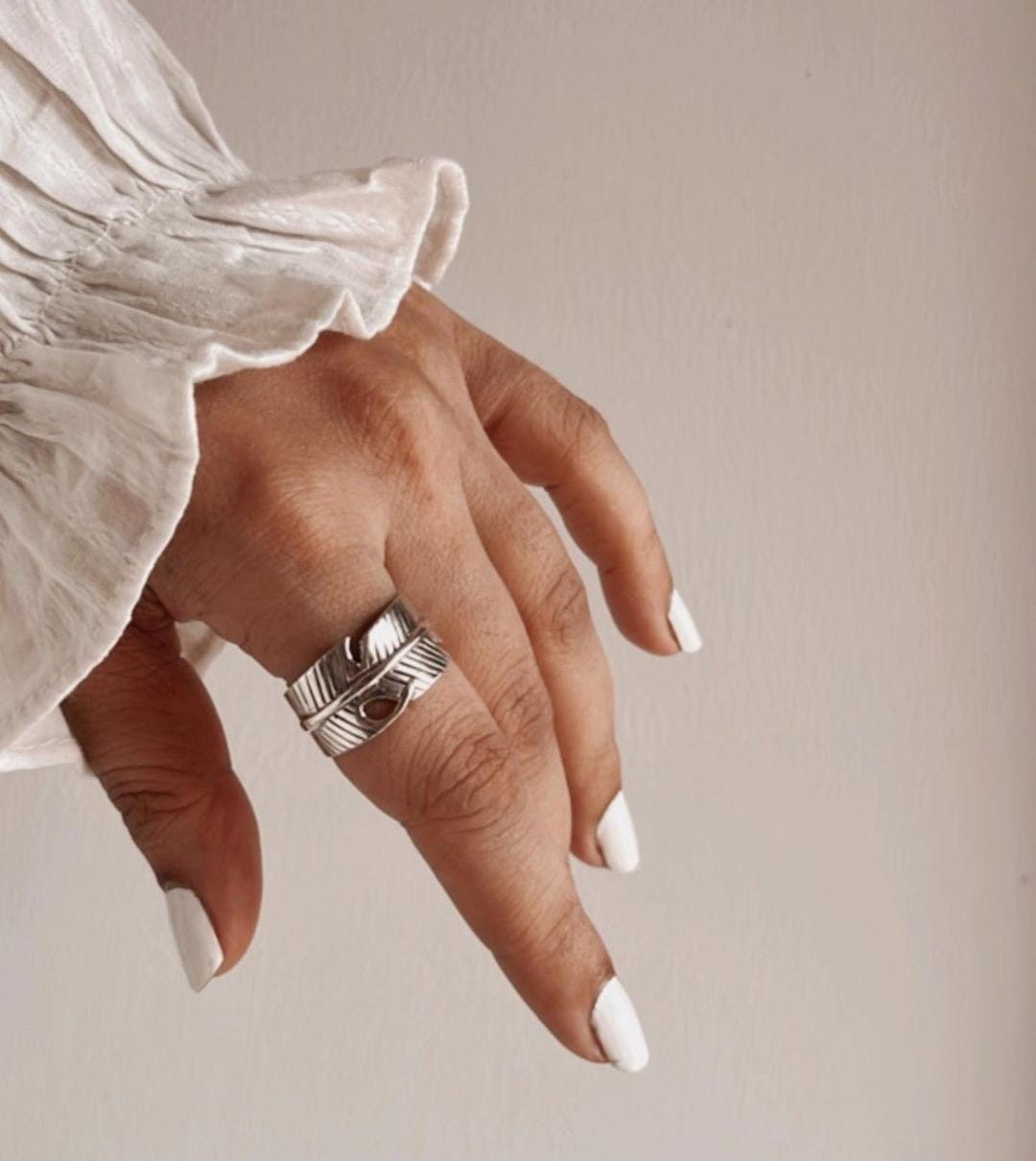Sophisticated feather wrap adjustable silver ring with graceful, flowing design