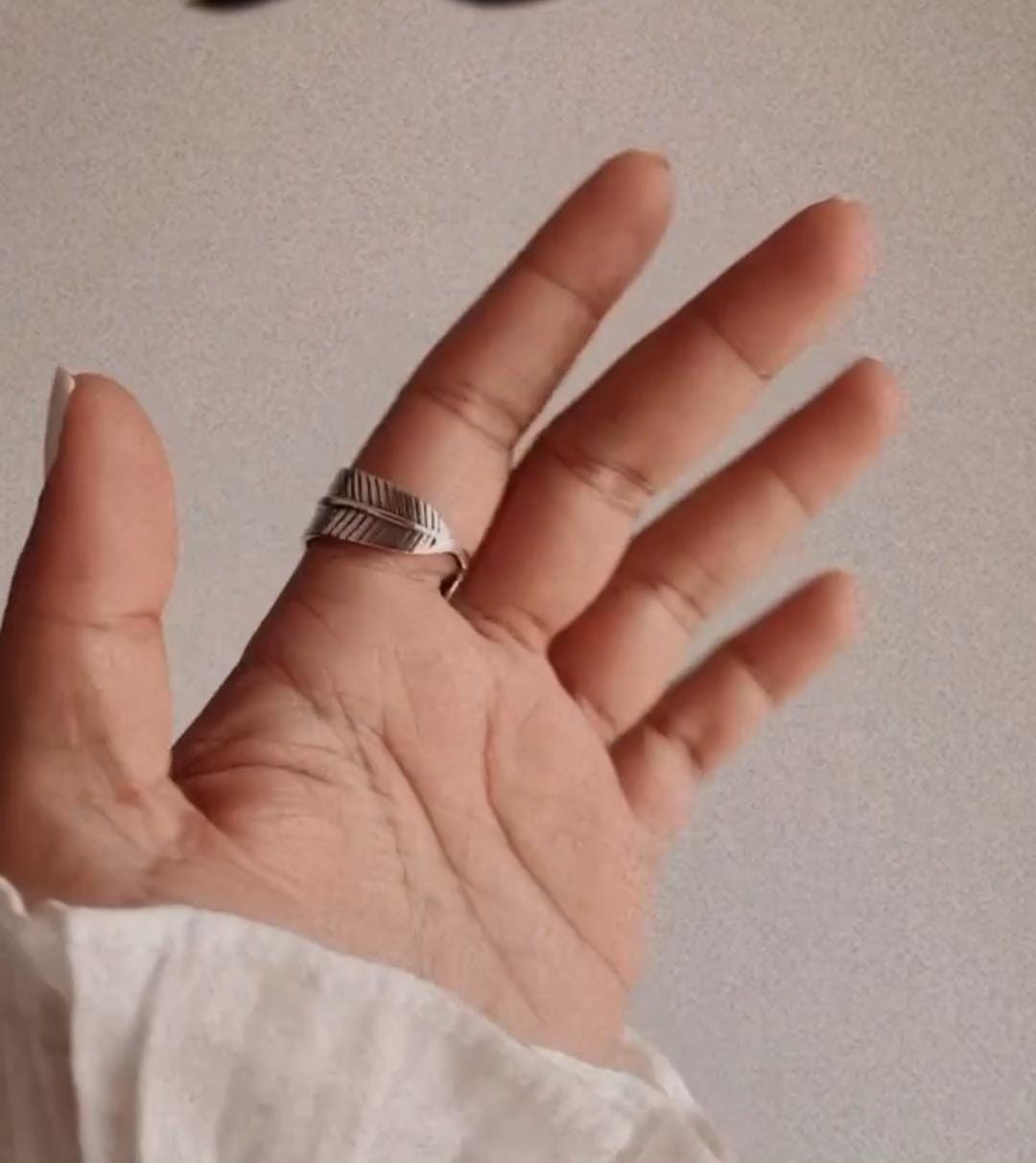 Handcrafted feather wrap adjustable silver ring with a boho chic vibe