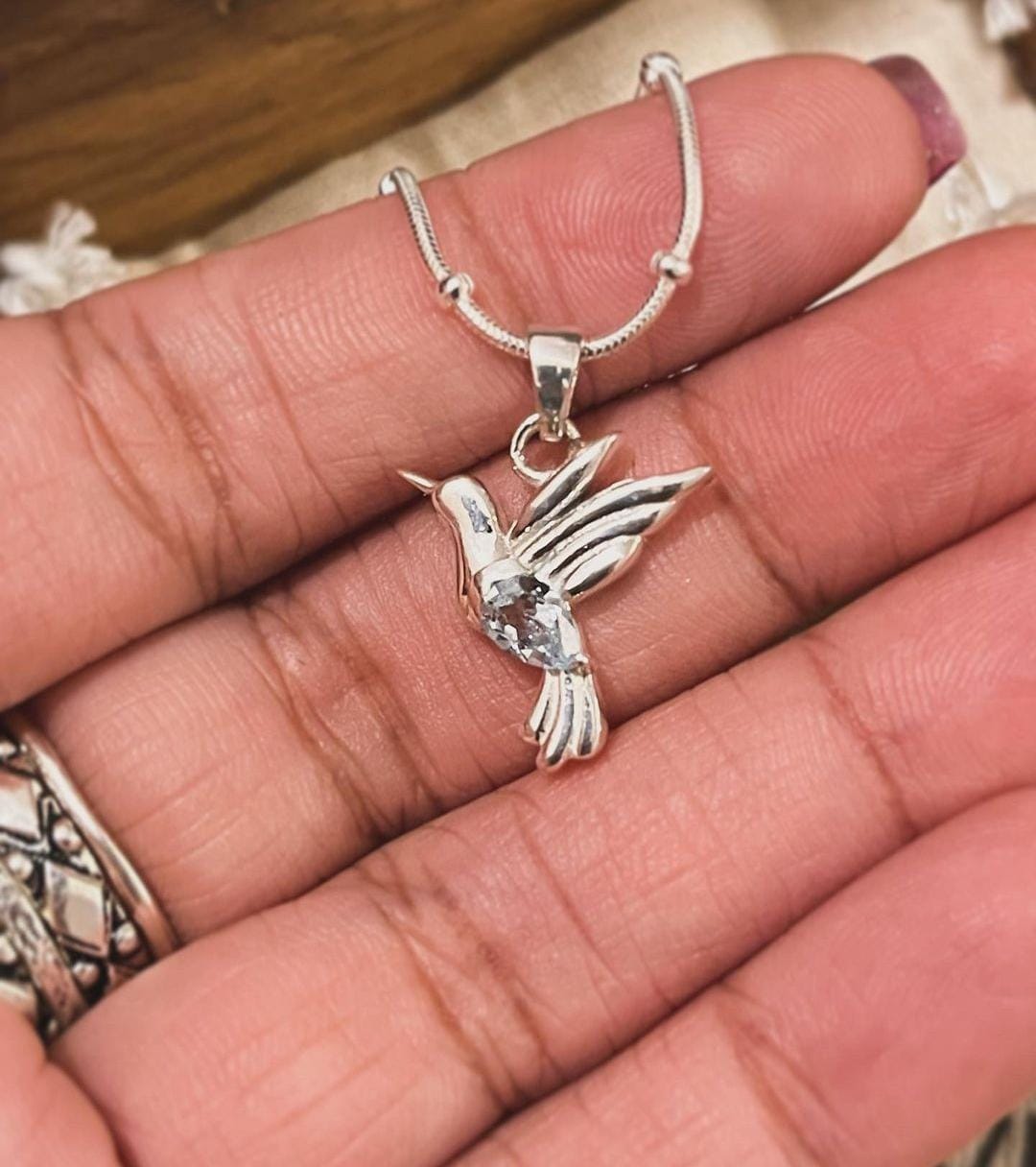Chic Blue Topaz Dove Pendant in Silver