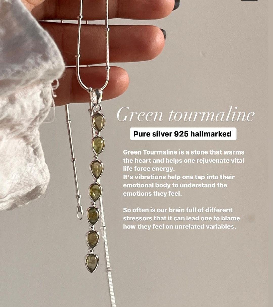 Green tourmaline pear stone pendant with a polished silver design