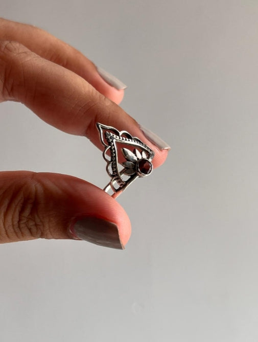 Garnet-studded silver ring with crown and boho elements