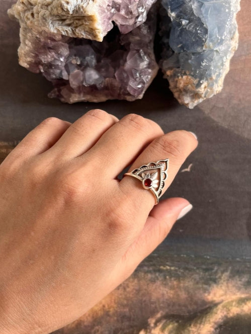 Boho-inspired silver ring featuring garnet and crown detailing
