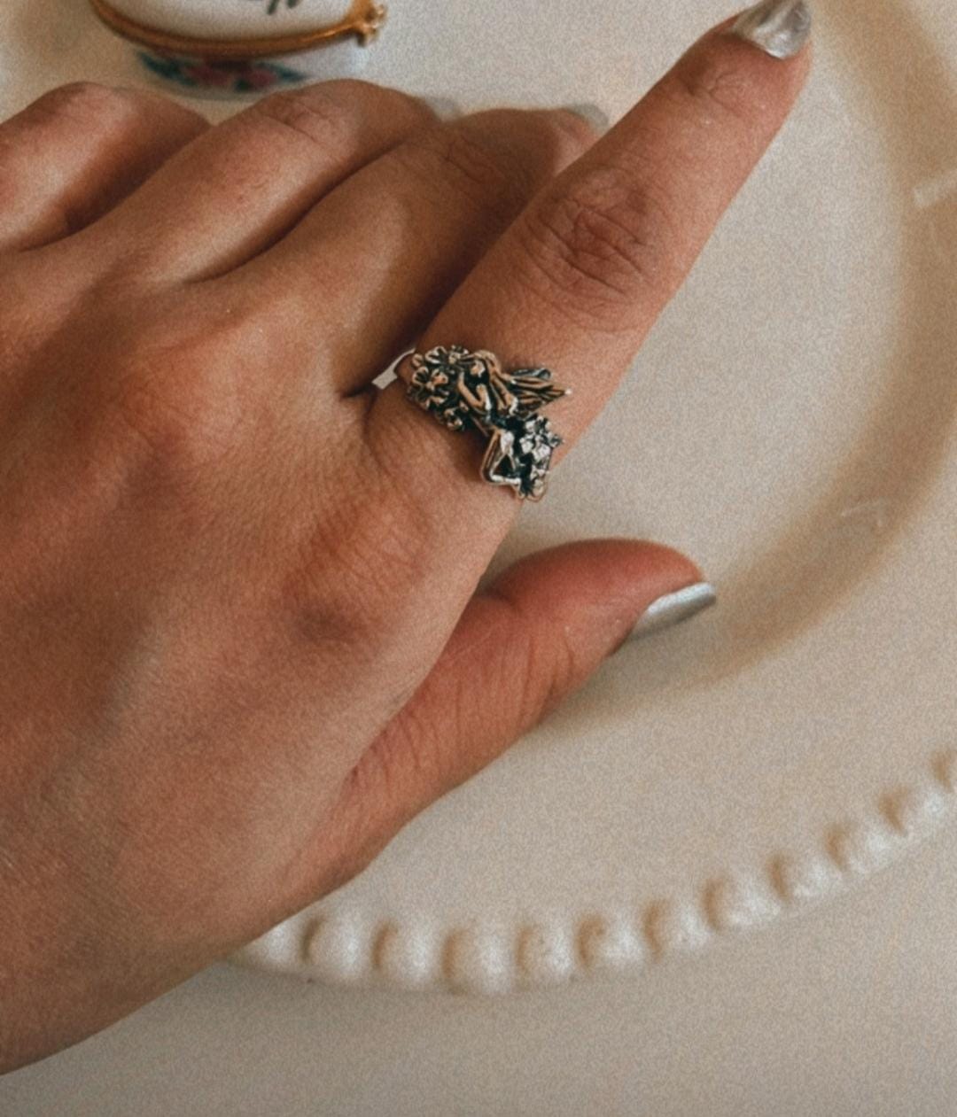 Unique fairy in the garden silver ring with fairy figure surrounded by flowers