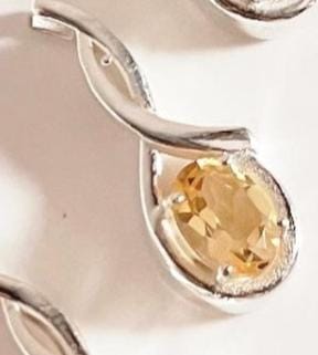 Elegant citrine solitaire stone set in a cross-shaped silver pendant