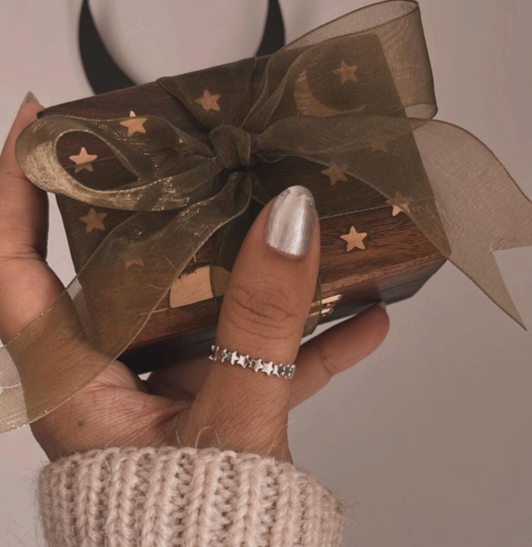 Delicate silver ring with small star pattern