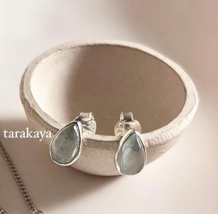 Timeless sterling silver studs featuring pear-shaped aquamarine cabochon stones.