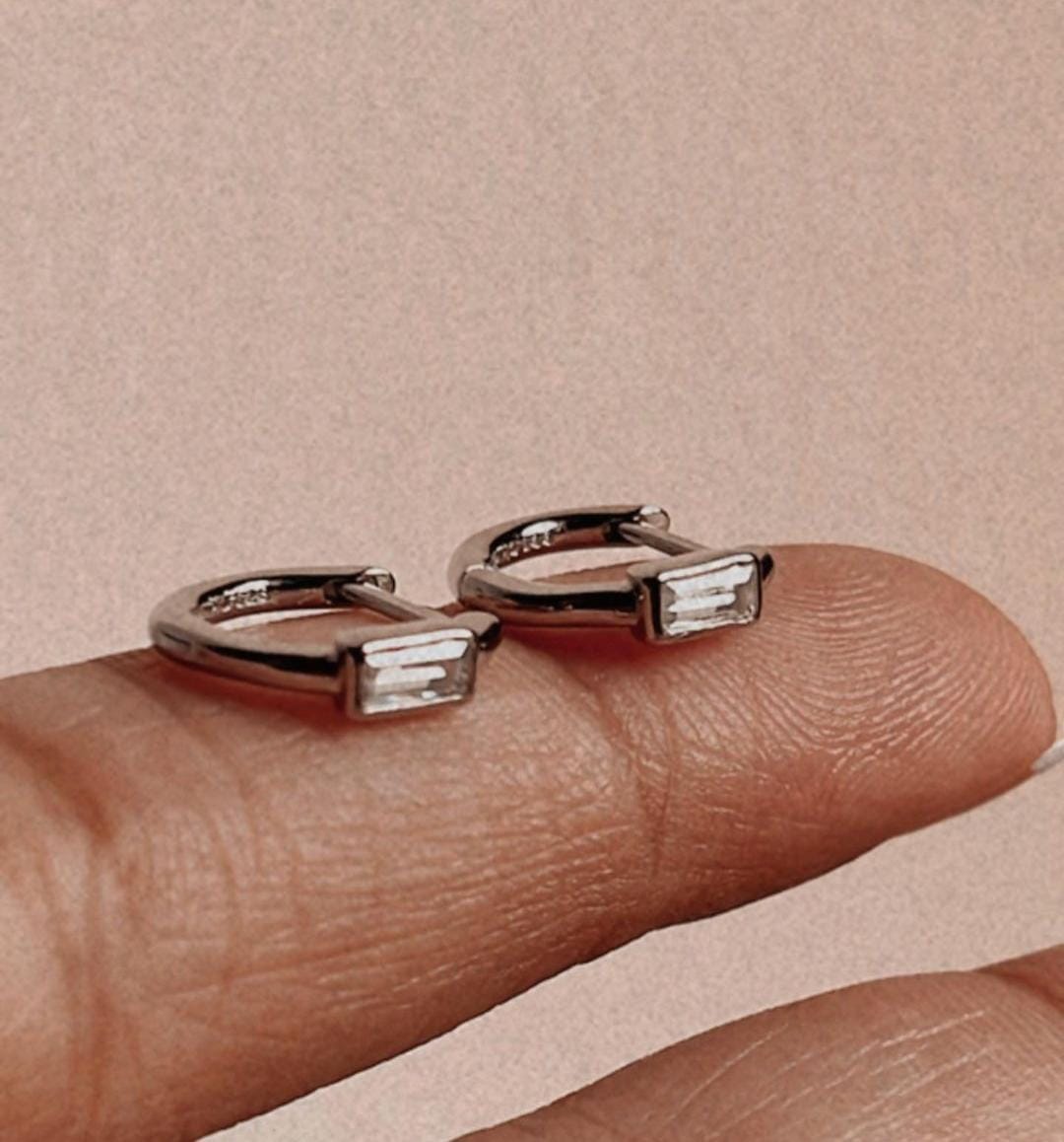 Delicate CZ silver huggie earrings with minimal design