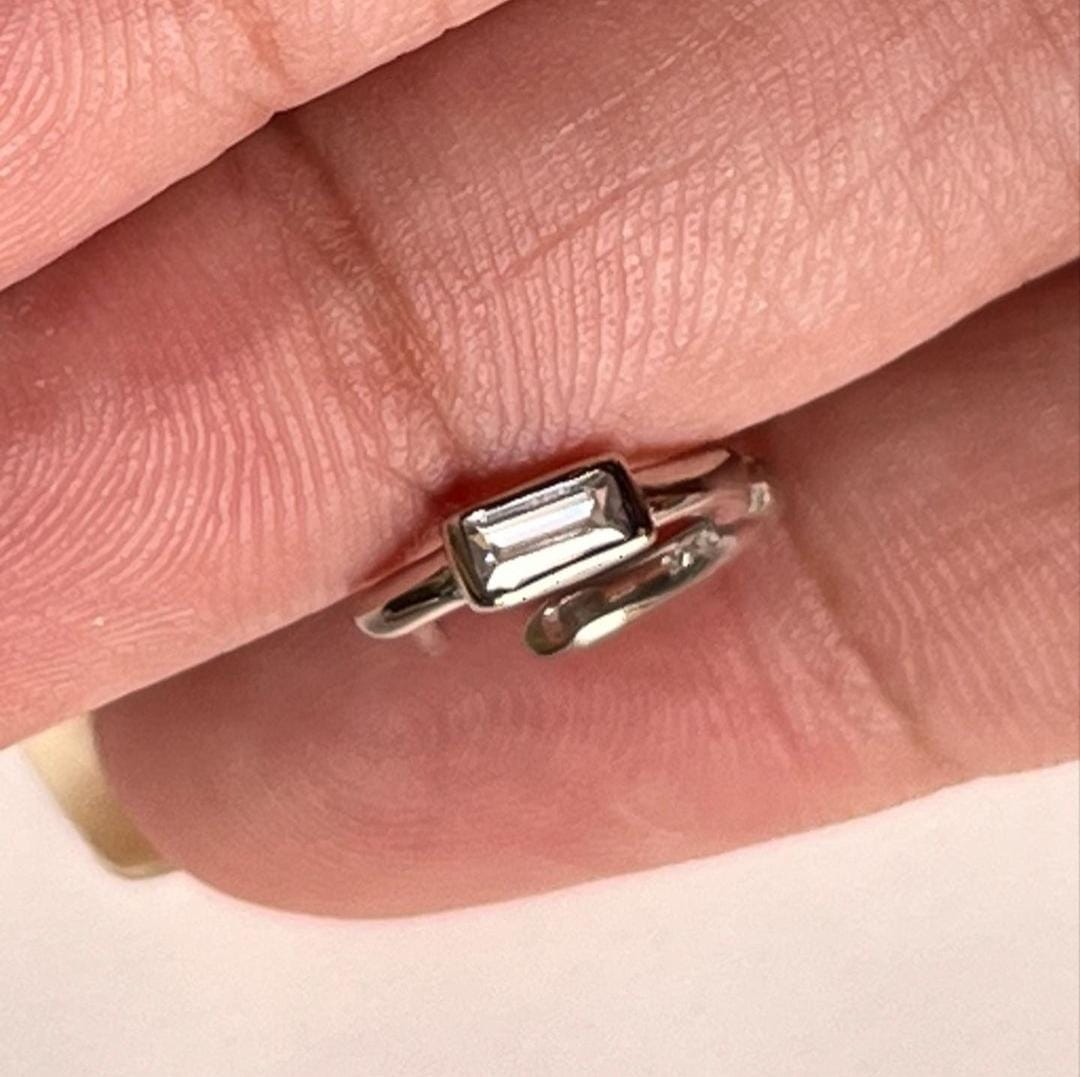 Close-up of tiny CZ silver huggie earrings with brilliant shine