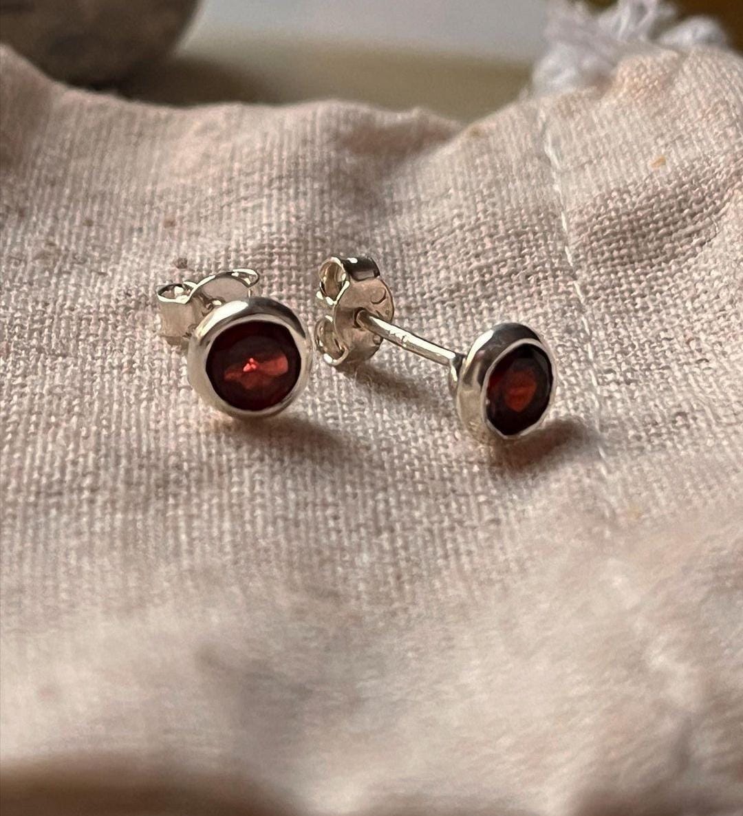 Small 4mm garnet stud earrings in a classic design