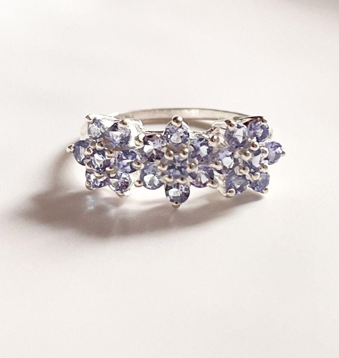 Elegant tanzanite three flower ring in sterling silver