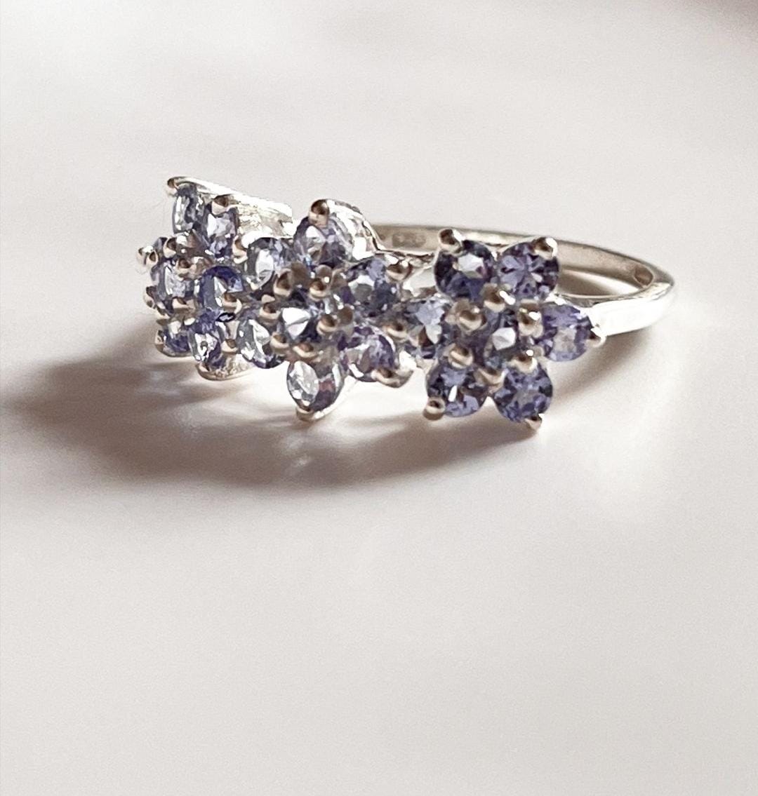 Stylish tanzanite silver ring with three flower motif