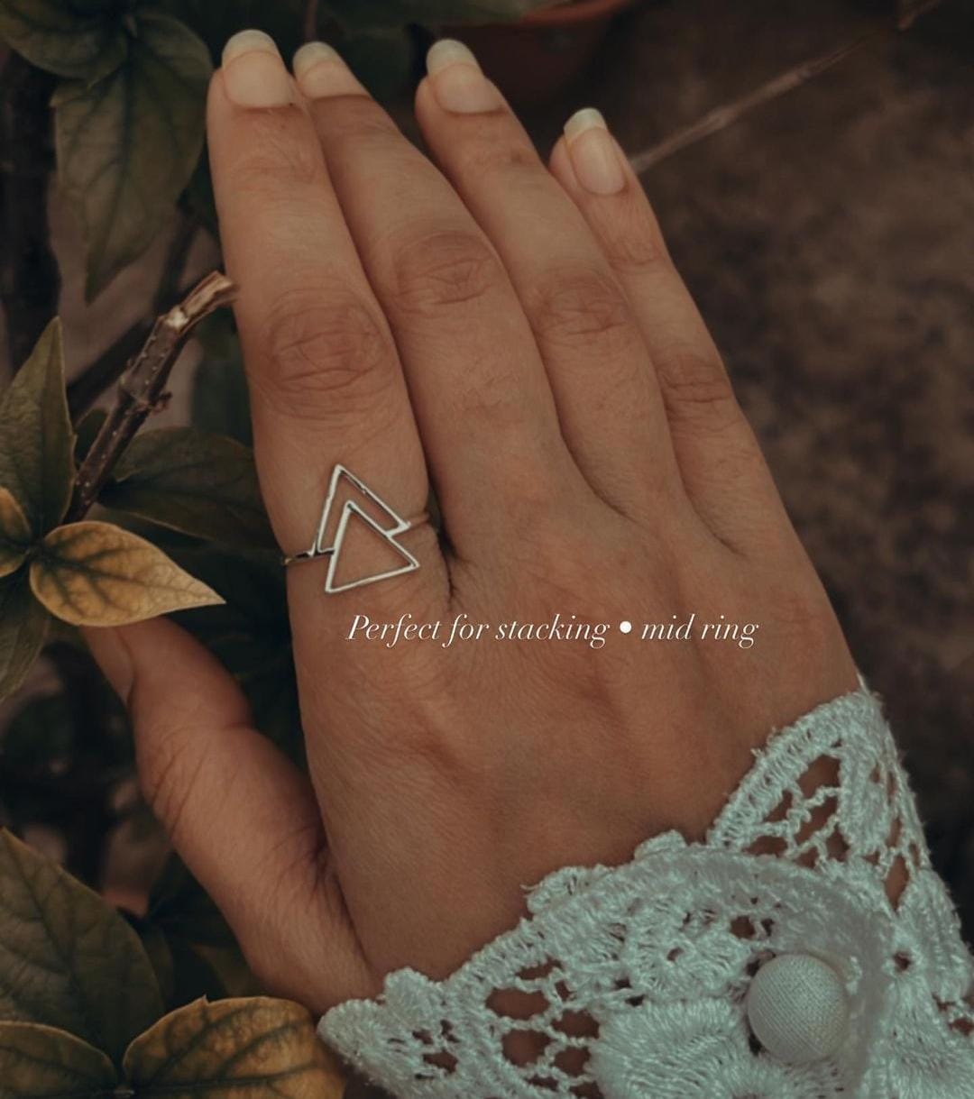 Close-up of double triangle silver ring with sharp, clean lines