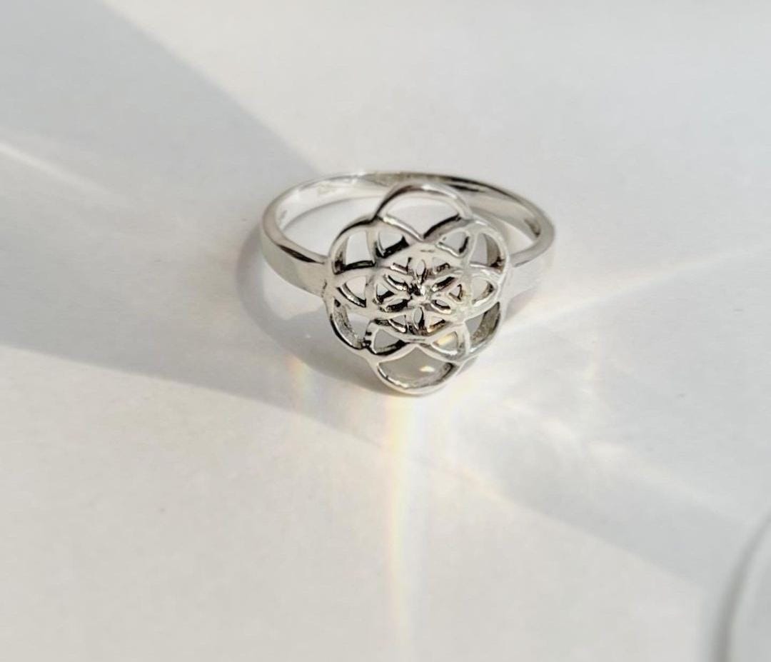 Handcrafted silver ring with Seed of Life geometric pattern