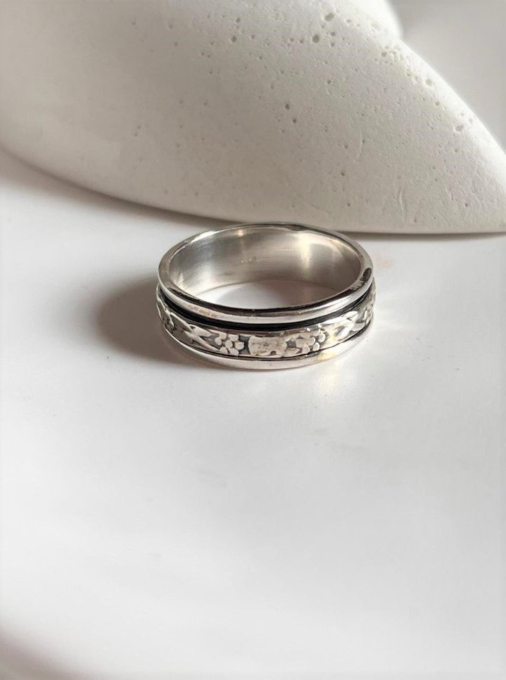 Handcrafted floral spinner silver ring with spinning floral accents