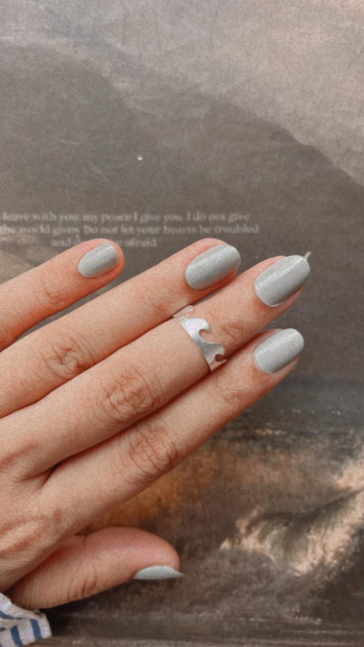 Sleek adjustable silver ring with wavy pattern