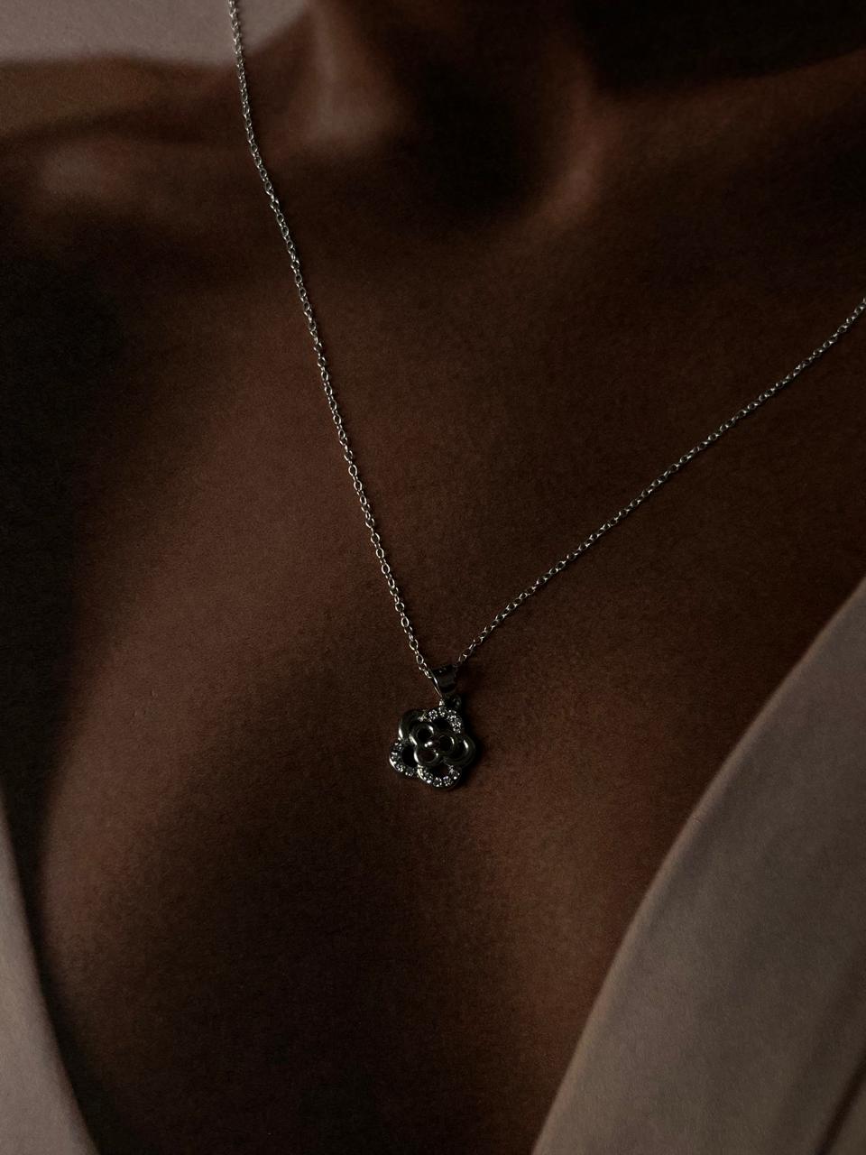 Sterling silver necklace featuring a delicate rose pendant