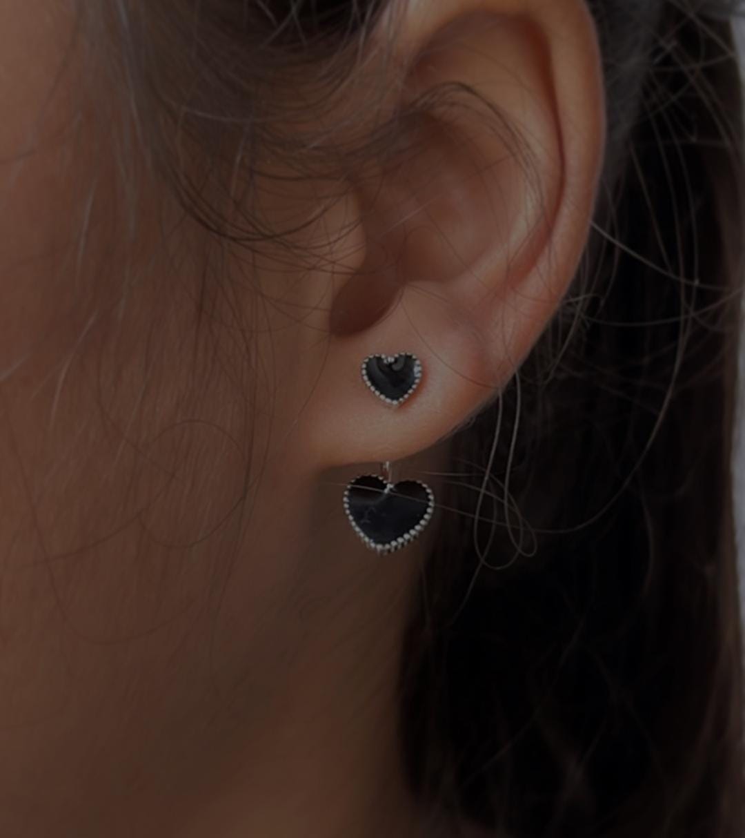 Minimalist black heart enamel silver studs with a smooth finish.