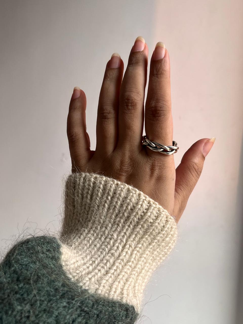 Close-up of chunky twist braided silver ring with adjustable band