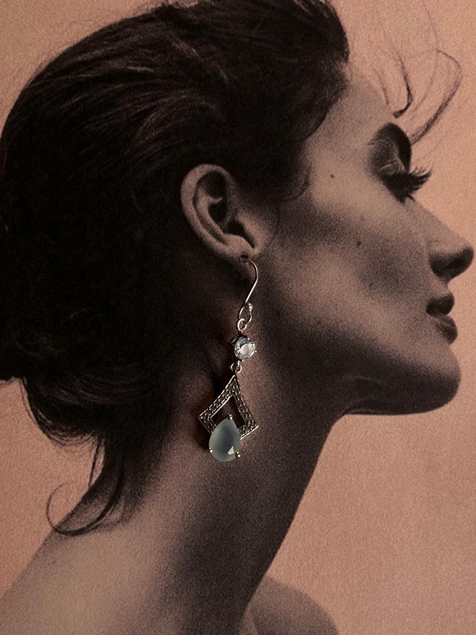 Sleek silver earrings with pear-cut aqua chalcedony and blue topaz gemstones.