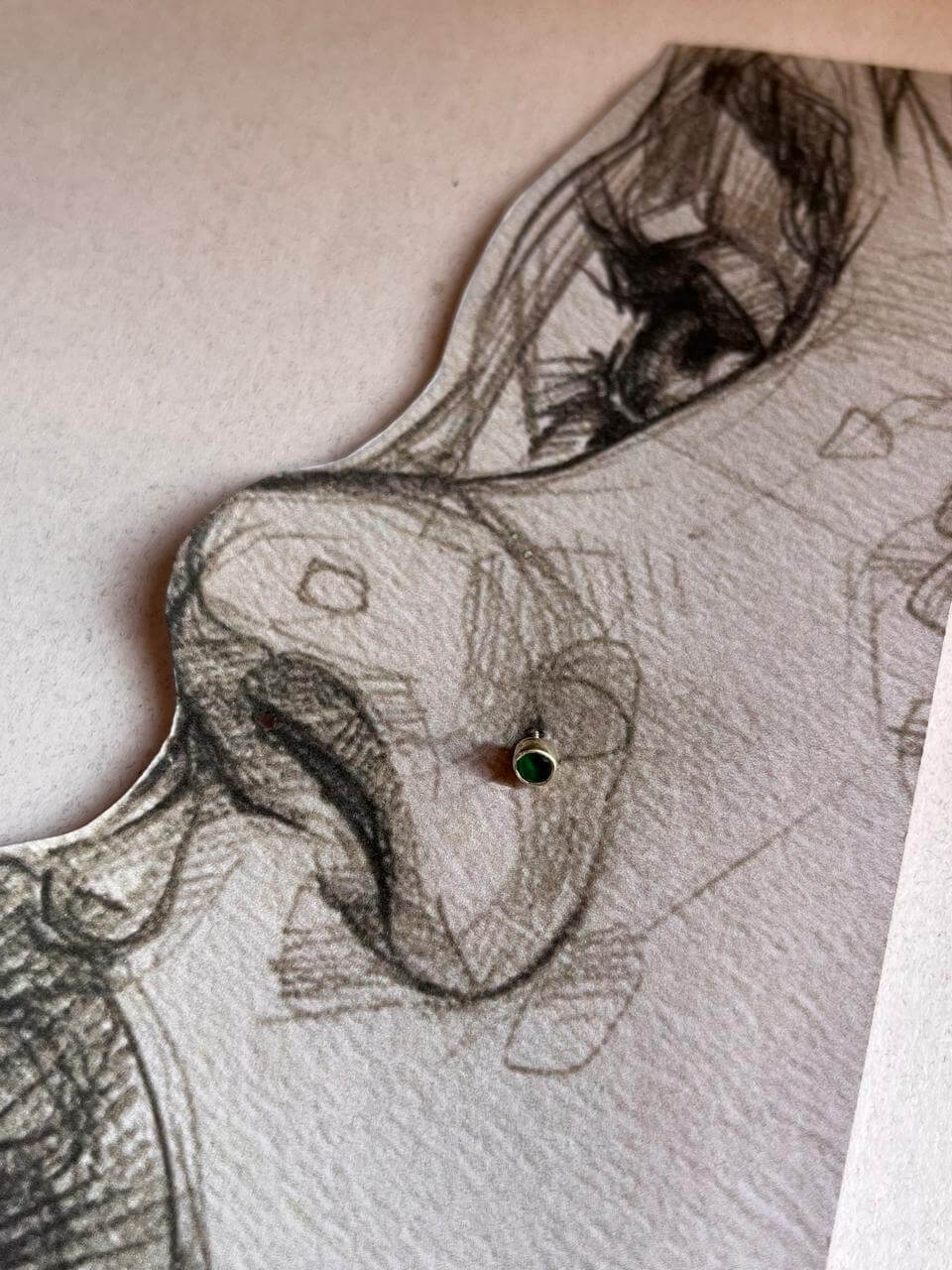 Minimalist silver nose pin with green cubic zirconia stone