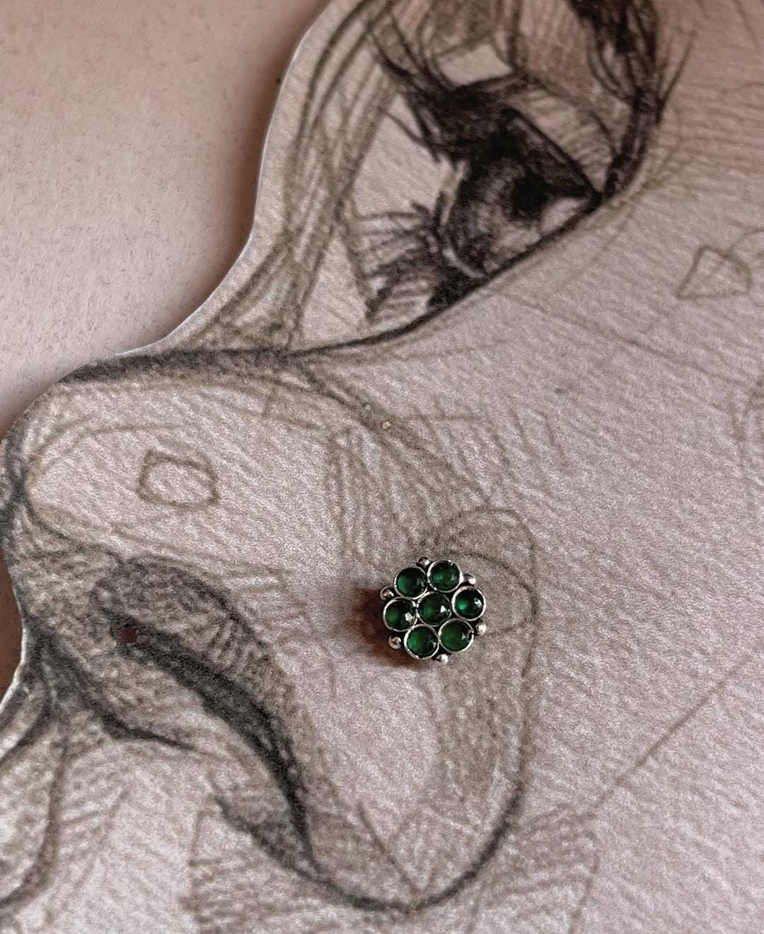 925 silver nose pin with tribal rawa design and green CZ stone