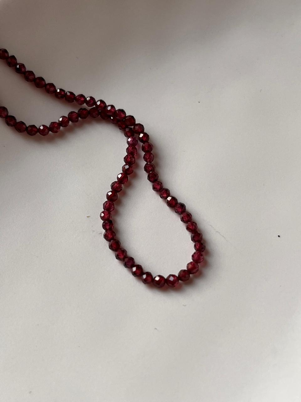 Close-up of Garnet 3-4mm Round Cut Crystal Necklace