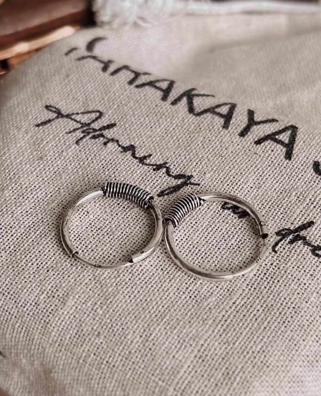 Handcrafted oxidised silver hoops with wire wrap design