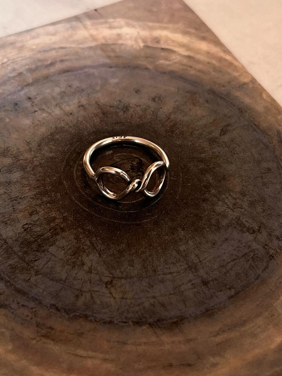 Handicrafts silver ring featuring infinity symbol twist