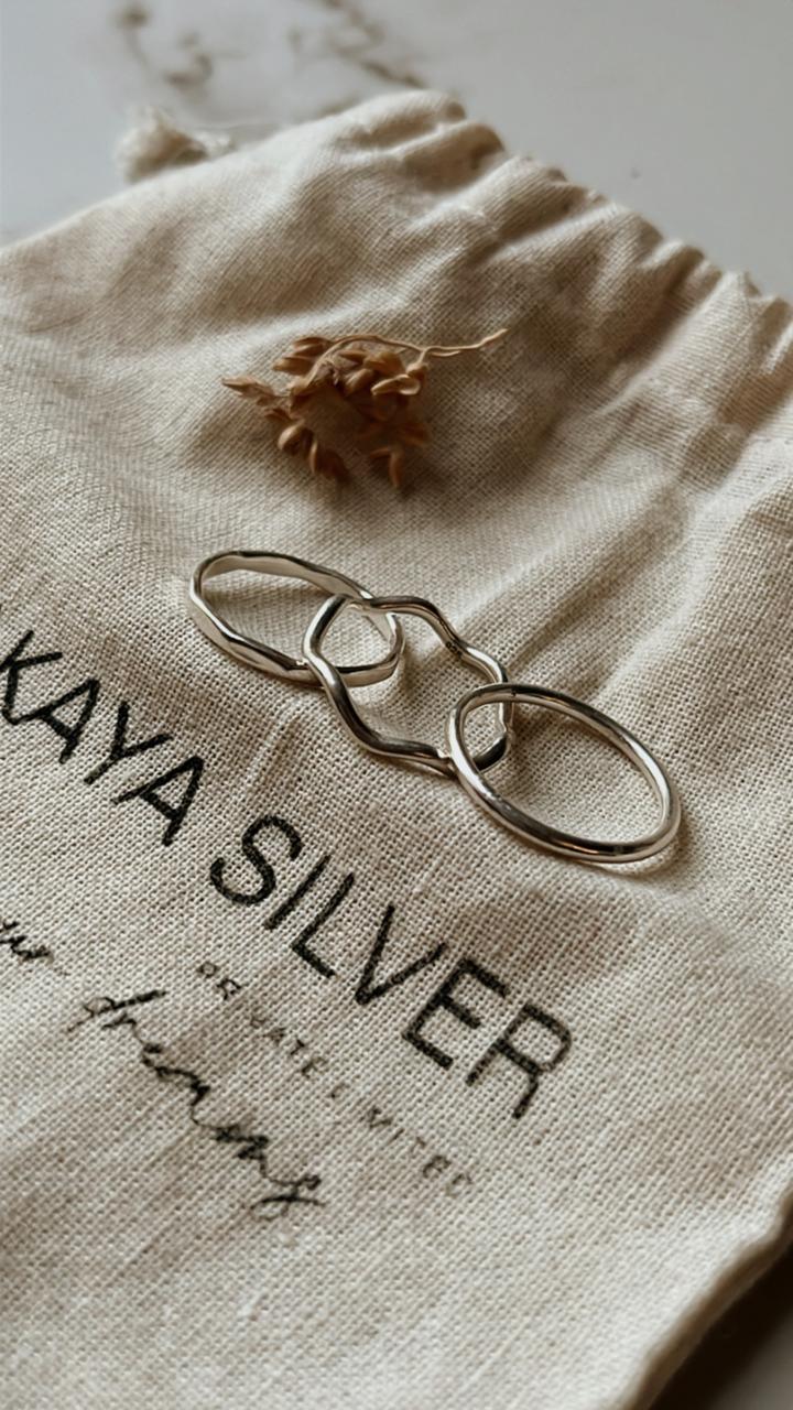 Stackable silver rings featuring wavy, plain, and hammered textures